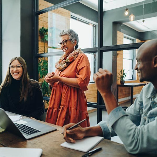 team of workers at a table smiling