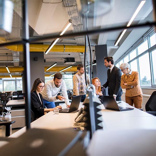 team of workers collaborating together in an office building