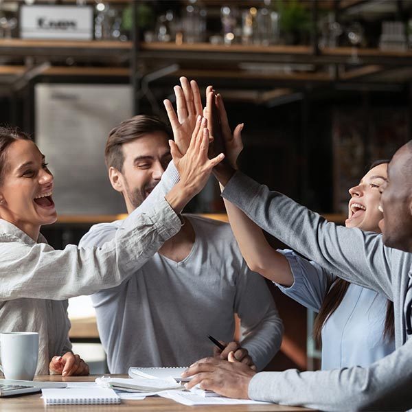 team of workers celebrating with a high five